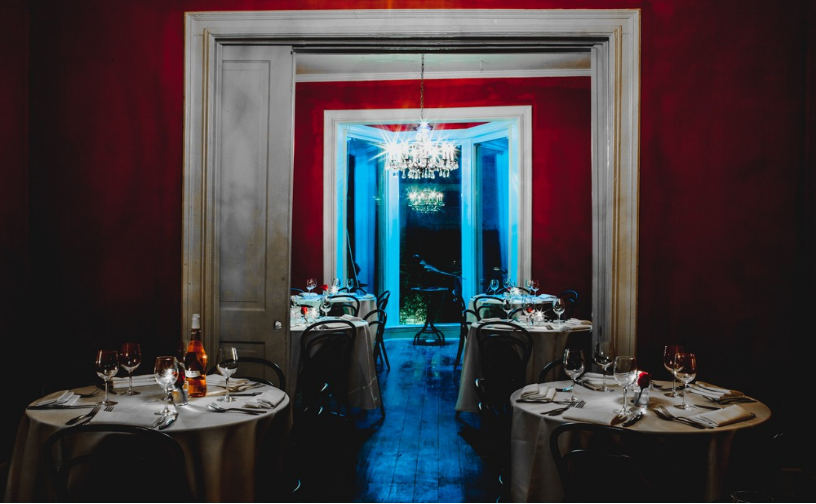 Candlelit dining tables arranged through Justine’s Secret House